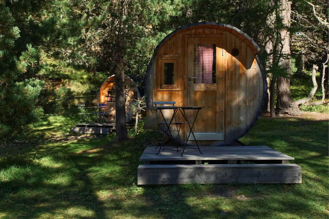 Wooden barrel cabins tucked in the forest